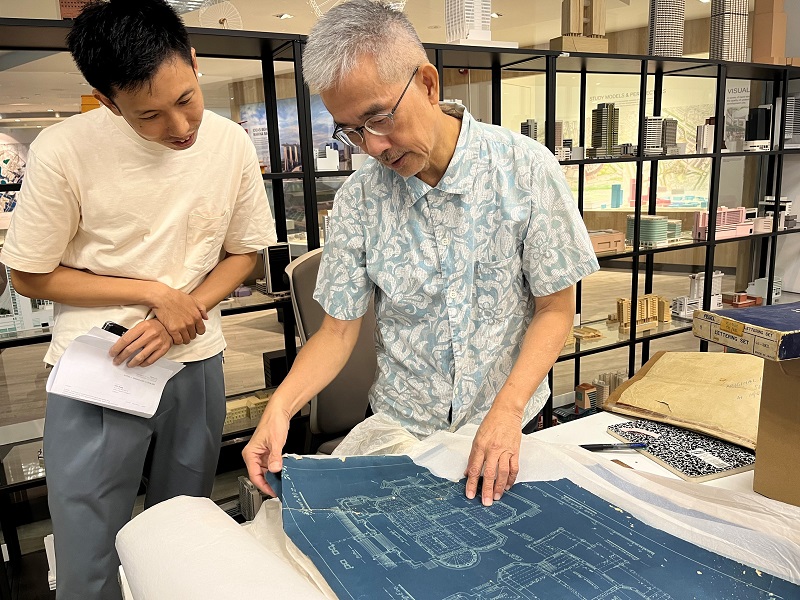 Dr Wong Yunn Chii showing architectural plans from his private collection to writer Justin Zhuang 